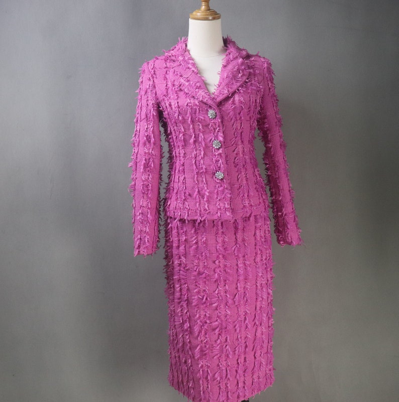 Indulge in timeless elegance with our Women's Custom Made Tweed Fitted Fluffy Tassel Blazer and Midi Skirt Hot Pink Suit—a statement ensemble crafted for making lasting memories on your most cherished occasions.