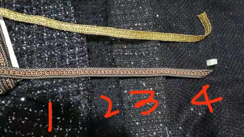May include: Four different types of trim, including gold, brown, and black, are shown on a black fabric background. The trim is labeled with numbers 1 through 4.