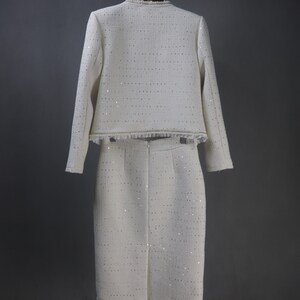 Back view of custom white formal suit with sequinned jacket and skirt, featuring pearl and chain trim – handmade outfit for weddings, graduations, or formal events
