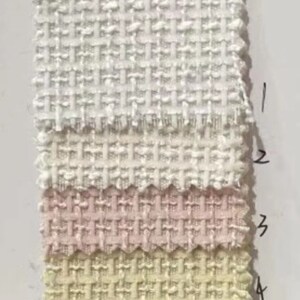May include: Five fabric swatches in different shades of white, pink, and yellow. The swatches are arranged vertically, with the lightest shade at the top and the darkest shade at the bottom. Each swatch has a woven texture.