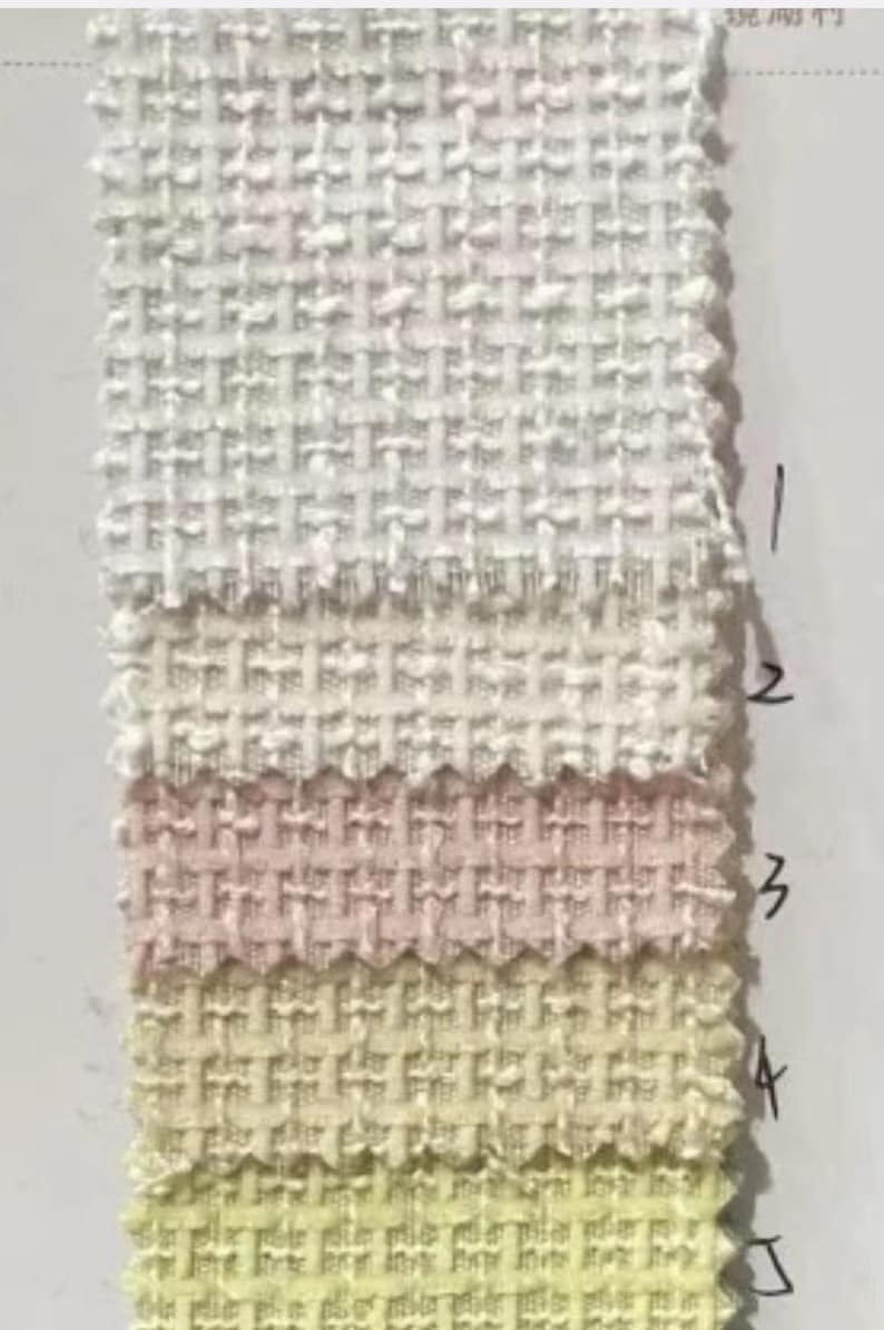 May include: Five fabric swatches in different shades of white, pink, and yellow. The swatches are arranged vertically, with the lightest shade at the top and the darkest shade at the bottom. Each swatch has a woven texture.
