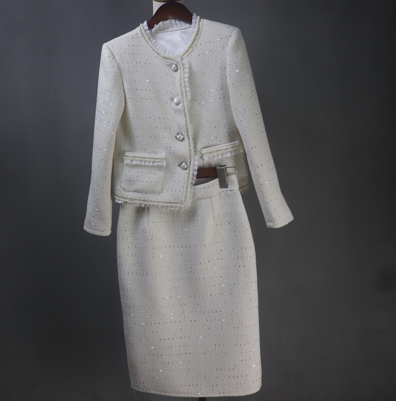 Front view of custom-made white sequin jacket and skirt set with pearl and chain trim – elegant women's formal suit for wedding, graduation, or evening dinner