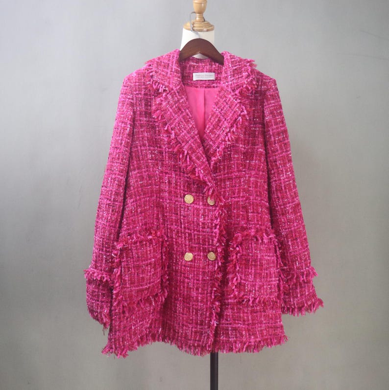 Custom-made hot pink tweed bouclé blazer jacket with double-breasted gold buttons and fringe trim on a dress form