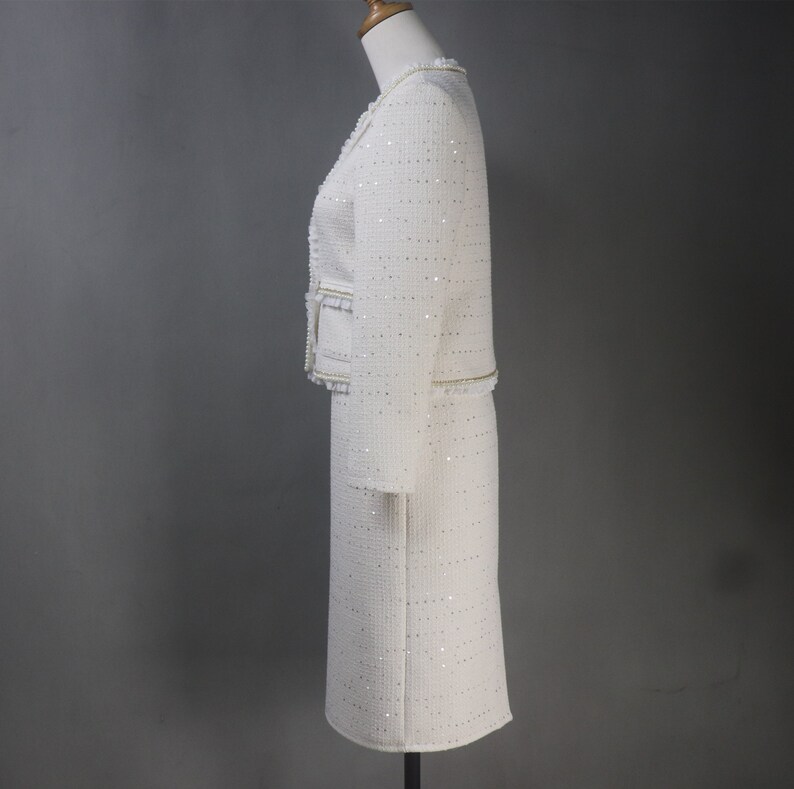 Side view of custom-made white sequin jacket and skirt set with pearl and chain trim – sophisticated women's formalwear for graduation, dinner, or special occasions