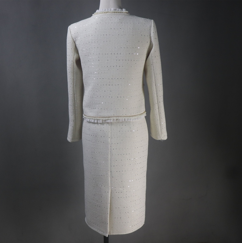 Back view of custom white formal suit with sequinned jacket and skirt, featuring pearl and chain trim – handmade outfit for weddings, graduations, or formal events
