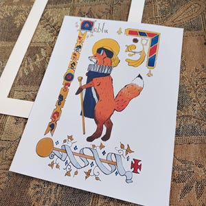 May include: A colorful illustration of a fox wearing a crown and robe, holding a staff. The fox is surrounded by decorative elements, including a key, a ribbon, and a cross. The illustration is in a medieval style.