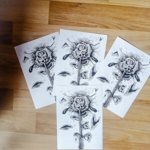 May include: Four black and white ink drawings of a single rose with a long stem and leaves. The roses are drawn in a stylized, almost abstract way, with the petals and leaves appearing as if they are made of water droplets.