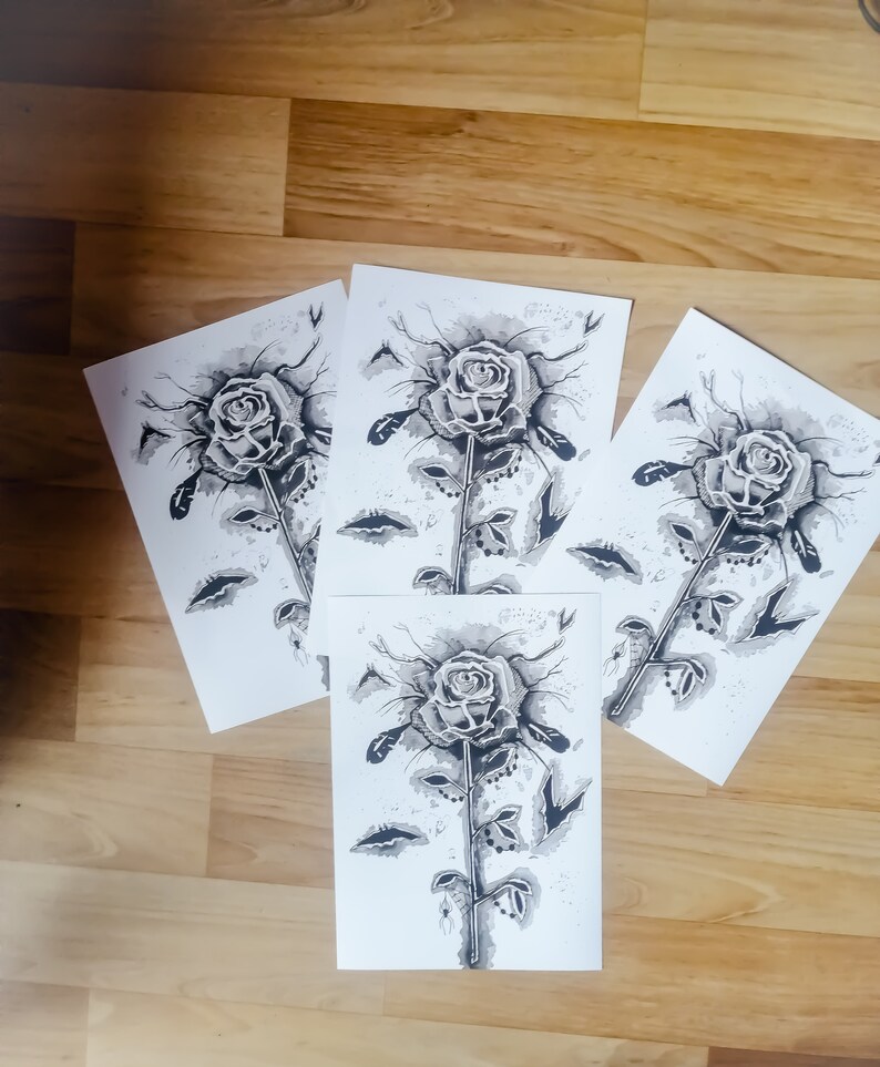 May include: Four black and white ink drawings of a single rose with a long stem and leaves. The roses are drawn in a stylized, almost abstract way, with the petals and leaves appearing as if they are made of water droplets.