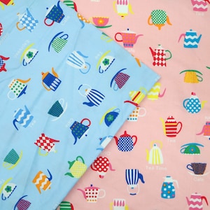 May include: Two fabric swatches with a repeating pattern of colourful teapots and cups. The top swatch is light blue with white text that says "Cafe", "Tea", and "Espresso". The bottom swatch is pink with white text that says "Cafe", "Tea", "Tea Time", and "Espresso".