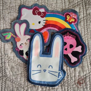 May include: A white ceramic mug with a black handle and the text "But First, Coffee" in a bold, black font. The mug is displayed on a white surface, showcasing its clean design.