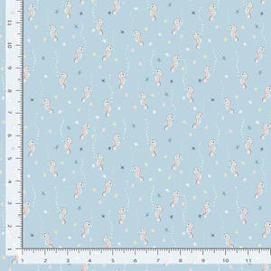 May include: Light blue fabric with a repeating pattern of seahorses, stars, and dotted lines. The seahorses are orange and white with black dots. The stars are pastel colors. This fabric is suitable for sewing projects.