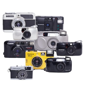 May include: A collection of vintage film cameras in various colors, including black, silver, and yellow. The cameras are from brands like Canon, Olympus, and Konica. Some cameras have visible lenses and flashes, showcasing classic camera designs.