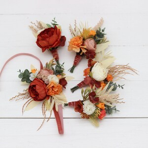 Burnt orange ivory accessories Wrist corsage Boutonniere Buttonhole Wedding flowers Groom Groomsmen