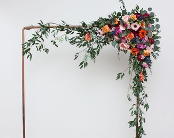 Jewel-tone wedding Emerald green orange pink magenta archway flowers Arbor flowers Pergola flowers Flower arrangement