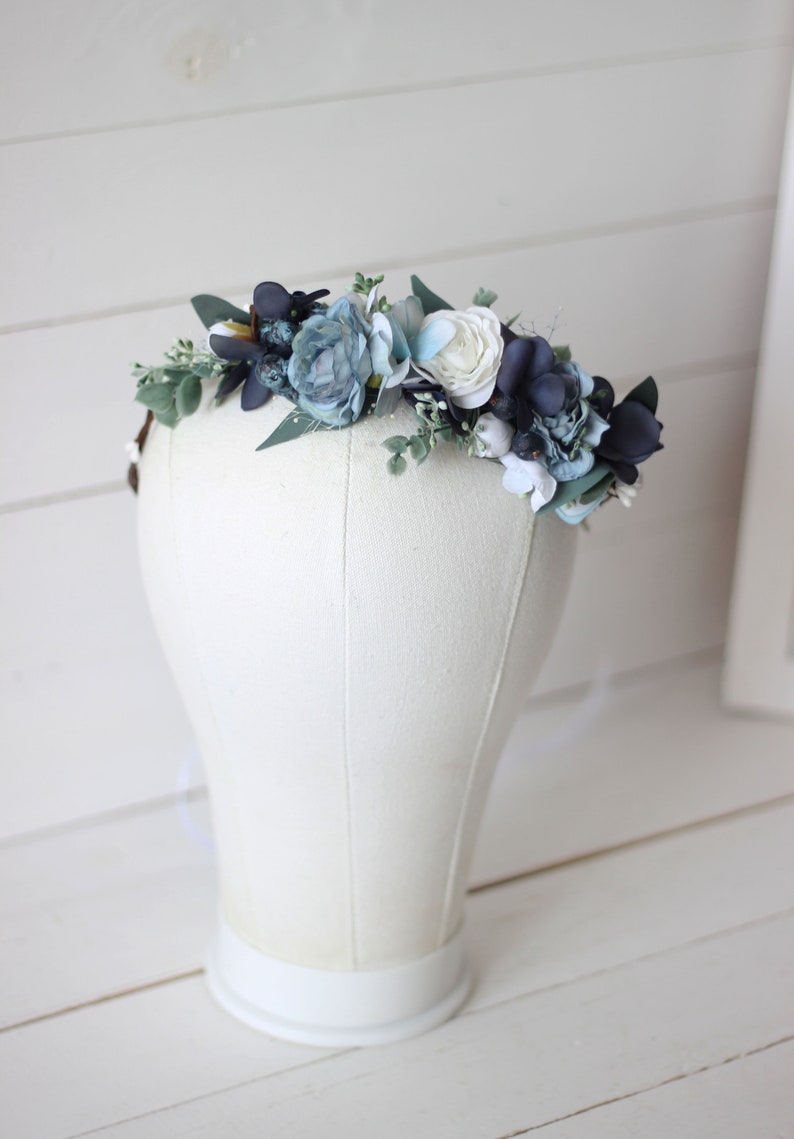 Pu&ograve; includere: Una corona floreale blu e bianca con foglie di eucalipto. La corona &egrave; realizzata con fiori di seta ed &egrave; perfetta per un matrimonio o un'occasione speciale.