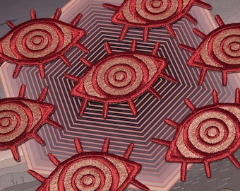 ピンクと赤の呪われた目のアイロン接着パッチ