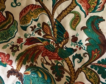 May include: A white fabric with a teal, brown, and red floral pattern. The pattern features a bird with a long tail and a leafy branch.