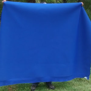 May include: A large, bright blue fabric backdrop, perfect for photography or video shoots.