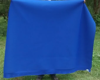 May include: A large, bright blue fabric backdrop, perfect for photography or video shoots.
