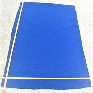 May include: A large, bright blue fabric rectangle with a measuring tape along the edge.