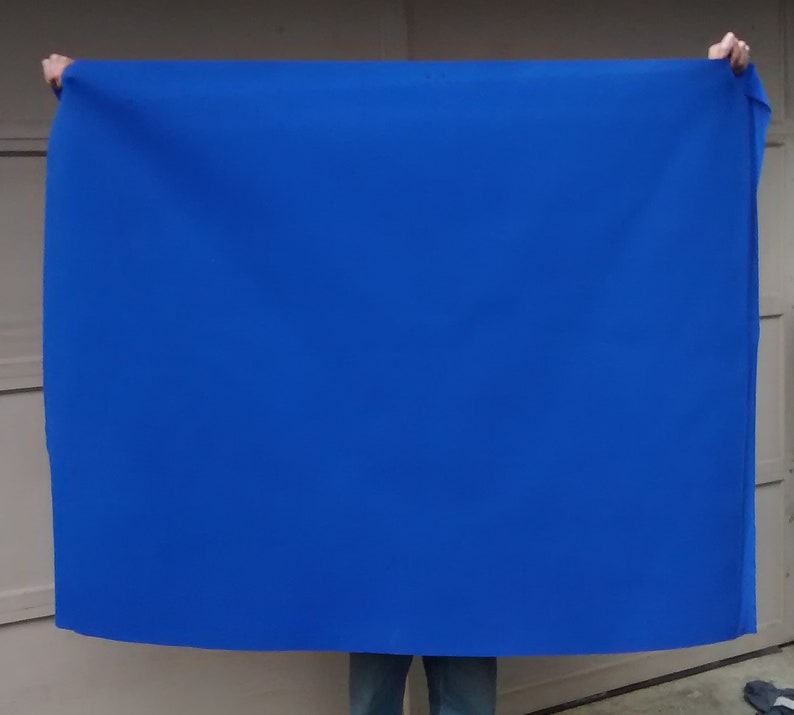 May include: A large, bright blue fabric backdrop, perfect for photography or video shoots.