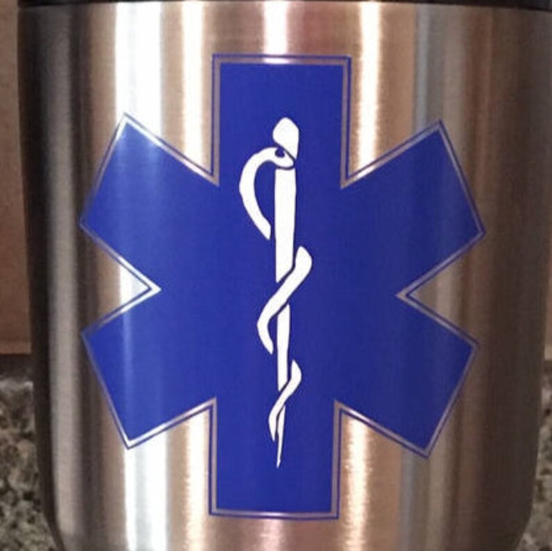 May include: A stainless steel tumbler with a blue star of life and a white caduceus symbol.
