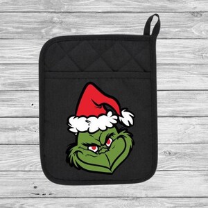 May include: Black oven mitt with a green and red Grinch character wearing a Santa hat.