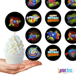 May include: A cupcake with white frosting is held in a hand. Surrounding the cupcake are black circular toppers with images of toy guns and children. Some toppers say "HAPPY BIRTHDAY STEPHON". A logo for "print first" is in the bottom right.