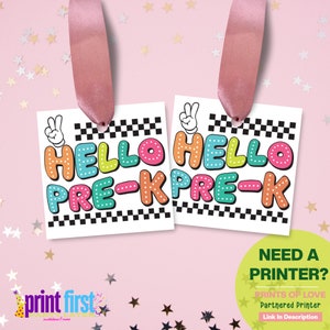May include: Two printable gift tags with a black and white checkered background. The tags feature the text "HELLO PRE-K" in colorful, outlined letters. The text is in a playful, cartoon font. The tags are attached to pink ribbon.