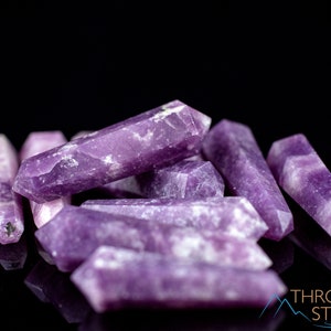 These Lepidolite crystal carved polished double terminated points range in a variety of handheld sizes.  Lepidolite  is mottled light to dark pinkish purple with white splotches.
Crystals are nature-made therefore each one is unique in appearance.