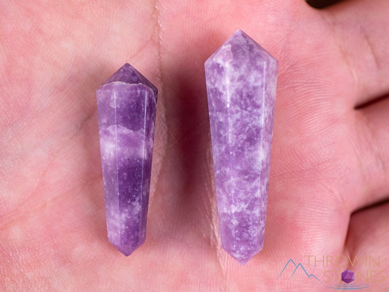 These Lepidolite crystal carved polished double terminated points range in a variety of handheld sizes.  Lepidolite  is mottled light to dark pinkish purple with white splotches.
Crystals are nature-made therefore each one is unique in appearance.