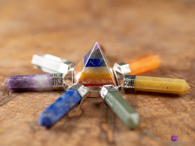 These crystal carved polished generators are a rainbow chakra crystal pyramid surrounded by 7 small points in each color of the rainbow chakras.
Crystals are nature-made therefore each one is unique in appearance.