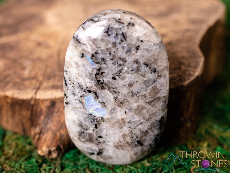 These Moonstone crystal carved polished palm stones range in a variety of handheld sizes.  Rainbow moonstone is white with black flecks and rainbow flashes.
Crystals are nature-made therefore each one is unique in appearance.