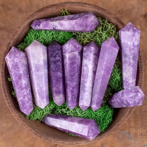 These Lepidolite crystal carved polished double terminated points range in a variety of handheld sizes.  Lepidolite  is mottled light to dark pinkish purple with white splotches.
Crystals are nature-made therefore each one is unique in appearance.