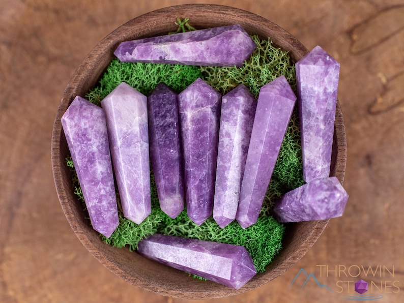 These Lepidolite crystal carved polished double terminated points range in a variety of handheld sizes.  Lepidolite  is mottled light to dark pinkish purple with white splotches.
Crystals are nature-made therefore each one is unique in appearance.