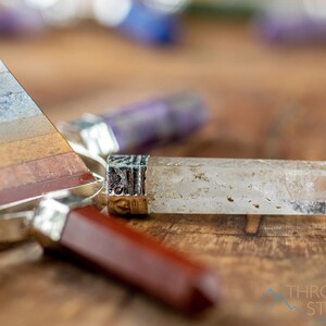 These crystal carved polished generators are a rainbow chakra crystal pyramid surrounded by 7 small points in each color of the rainbow chakras.
Crystals are nature-made therefore each one is unique in appearance.