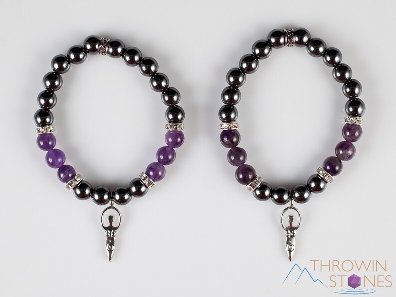 These purple Amethyst and grey Hematite crystal bracelets have round beads strung on elastic.  They feature a silver Goddess Charm.
Crystals are nature-made therefore each one is unique in appearance.