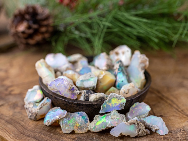 These raw Opal crystals are chunk shaped and rainbow colored with patches of tan matrix.
Crystals are nature-made therefore each one is unique in appearance.