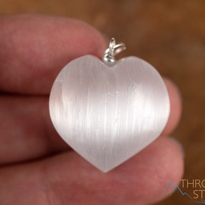 These chatoyant white Selenite crystal pendants are heart shaped, with a silver bail. 
Crystals are nature-made therefore each one is unique in appearance.