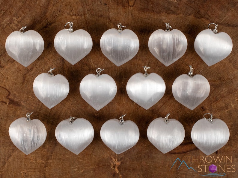 These chatoyant white Selenite crystal pendants are heart shaped, with a silver bail. 
Crystals are nature-made therefore each one is unique in appearance.