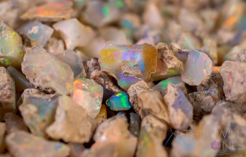 These raw Opal crystals are chunk shaped and rainbow colored with patches of tan matrix.
Crystals are nature-made therefore each one is unique in appearance.