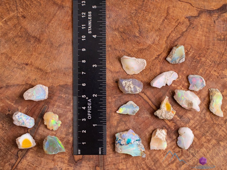 These raw Opal crystals are chunk shaped and rainbow colored with patches of tan matrix.
Crystals are nature-made therefore each one is unique in appearance.