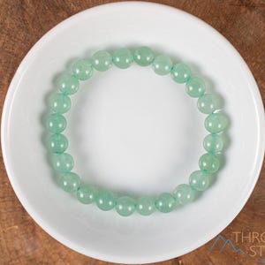 These pastel green Aventurine crystal bracelets have sphere beads strung on elastic for an endless bracelet. 
Crystals are nature-made therefore each one is unique in appearance.