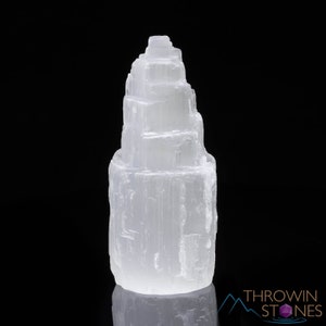 These white Selenite crystal carved raw tiered towers range in a variety of handheld sizes.  
Crystals are nature-made therefore each one is unique in appearance.