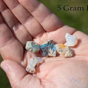 These raw Opal crystals are chunk shaped and rainbow colored with patches of tan matrix.
Crystals are nature-made therefore each one is unique in appearance.