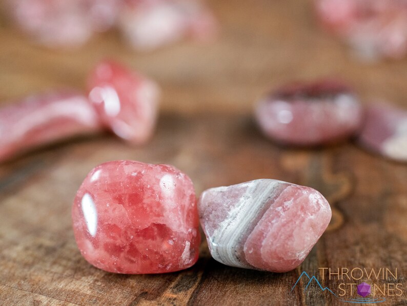 Rhodochrosite Crystal Chips. These stones are light pink to bright pink and often include a white banding. They are great for jewelry making and crystal decor. Each specimen is unique and varies in color, shape, and pattern. Listing has variations.