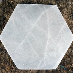 These are white Selenite crystal carved polished hexagon plates.
Crystals are nature-made therefore each one is unique in appearance.