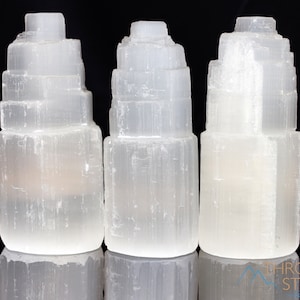 These white Selenite crystal carved raw tiered towers range in a variety of handheld sizes.  
Crystals are nature-made therefore each one is unique in appearance.