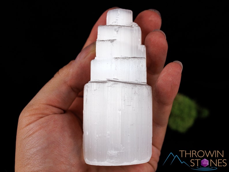 These white Selenite crystal carved raw tiered towers range in a variety of handheld sizes.  
Crystals are nature-made therefore each one is unique in appearance.