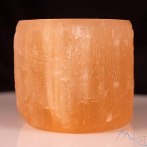 These peachy orange Selenite crystal carved raw cylindrical votive candle holders range in a variety of sizes.  
Crystals are nature-made therefore each one is unique in appearance.